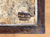 a close up of a rusted metal object on a wooden table