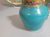 a tea pot and a plate on a table