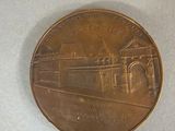 a close up of a coin with a building on it