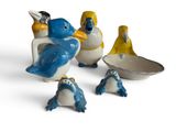 five figurines of penguins sitting next to each other