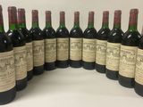 six bottles of wine lined up in a row on a table