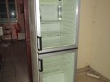 an image of a refrigerator in a room with tile flooring