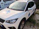 a white car that is parked in front of an ambulance