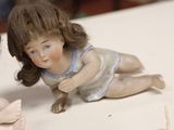 two little dolls sitting next to each other on a table