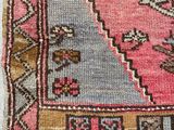 a pink and blue rug with a pattern on it