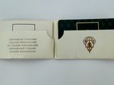 a small card holder with a picture of a crest on it