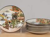 a stack of plates sitting on top of a wooden table