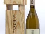 La bouteille de vin se trouve à côté d'une caisse en bois contenant une bouteille.