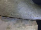 a close up of a bronze statue of a dog