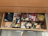 a drawer with many items in it and a pair of shoes