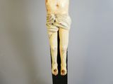 a statue of jesus on the cross on a black pole