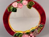 a picture of a red mirror with flowers on it
