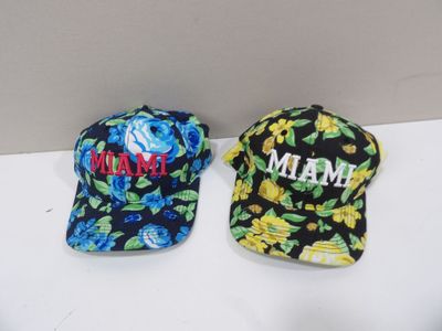two baseball caps that are sitting on a table