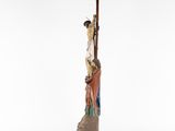 a figurine of jesus on the cross with a woman holding a cross