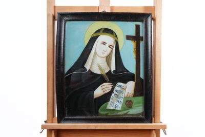 tableau représentant une femme avec un chapelet et une croix posés sur un chevalet