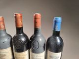 several bottles of wine are lined up on a table