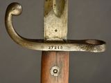 a close up of a sword with a wooden handle