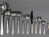several spoons, forks, and spoons are lined up on a table