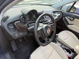 the interior of a small car with a steering wheel and dashboard