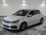 la voiture blanche est garée sur un sol en damier dans le garage