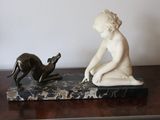 a statue of a child and a dog on a table