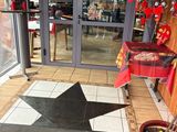 a black star rug on the floor in front of a store