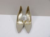 a close up of a pair of gold shoes on a white surface