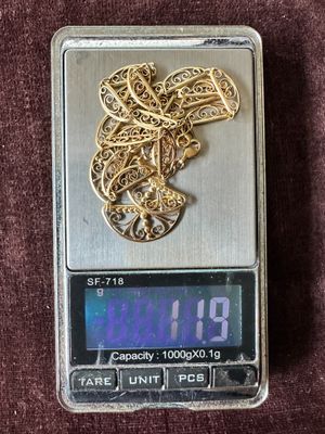 a small scale with a gold heart on it