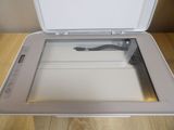 a white printer sitting on top of a wooden table