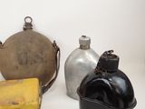 many different types of metal containers on a white surface
