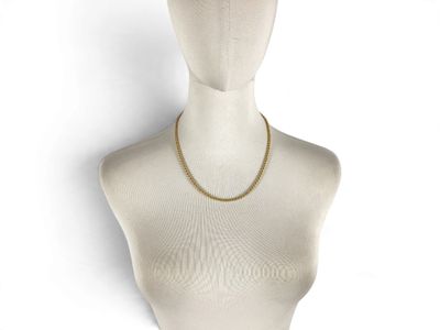 the mannequin has a gold chain on it ' s neck