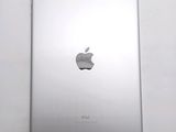 an apple ipad sitting on top of a white table next to a white wall