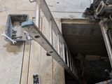 a ladder that is sitting in a hole in the floor
