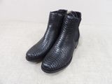 a pair of black leather boots on a white surface