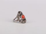 a close up of a ring with an orange stone on it