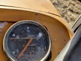 a close up of a speedometer on a yellow vehicle