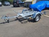 a trailer with a trailer attached to it in a parking lot