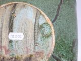 a close up of a vase with a sticker on it
