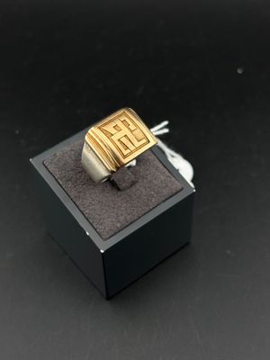an image of a gold and silver ring in a black box