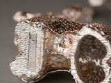 a close up of a silver object on a table