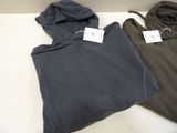 two hoodies that are sitting on a table