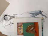a drawing of a man laying on a bed next to a painting
