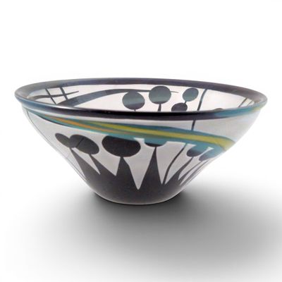 a black and white bowl with blue and green designs on it