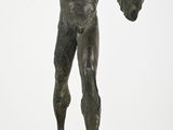 bronze statue of a boy holding a baseball glove and a ball