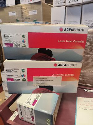 three toner cartridges are stacked on top of each other on a table