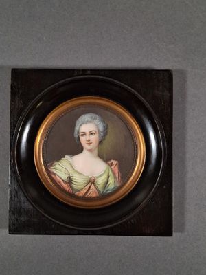 portrait of a woman in a green dress in a black frame