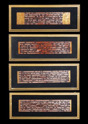 a group of four framed plaques with writing on them