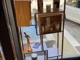 a display case in the corner of a room with a window