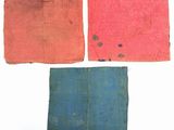 four pieces of cloth are laid out on a white surface