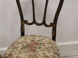 a small chair with a floral seat and back